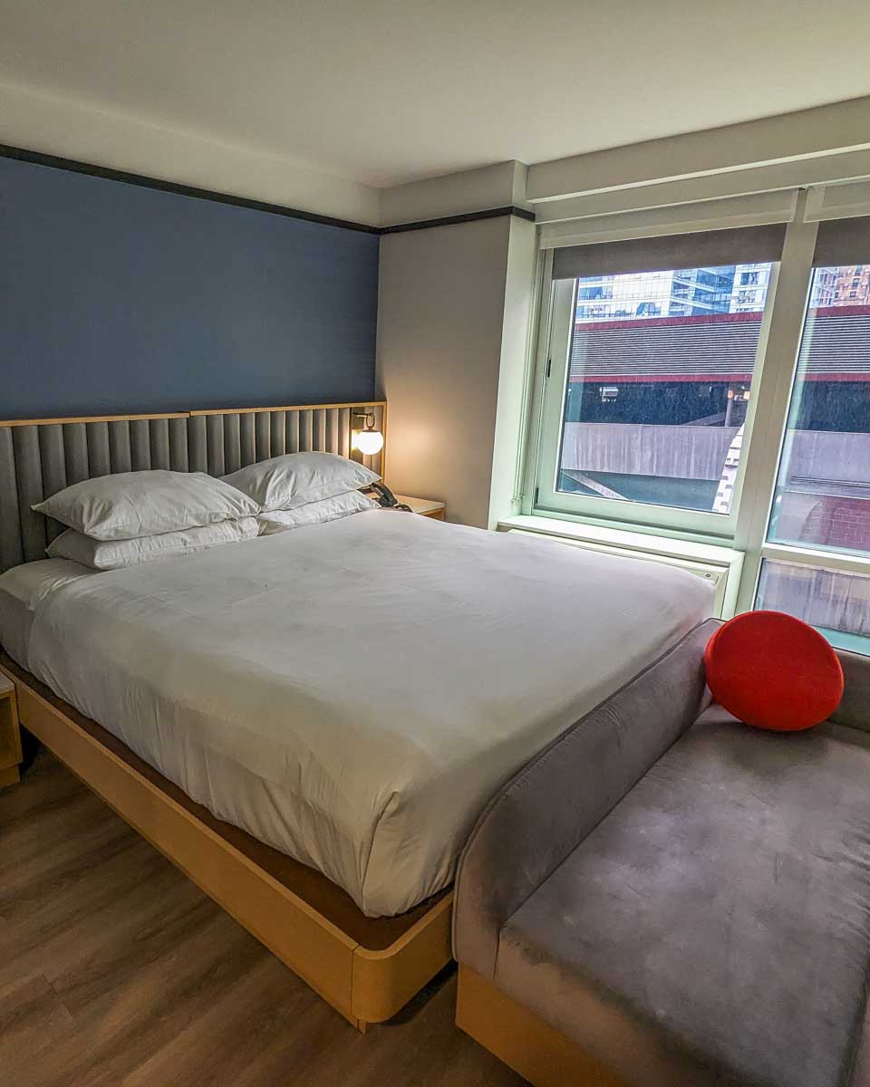 the bed inside TBA Times square hotel in a modern room