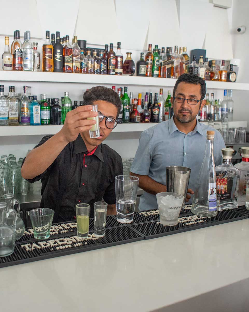 A bar tender makes a pisco sour in Lima Peru
