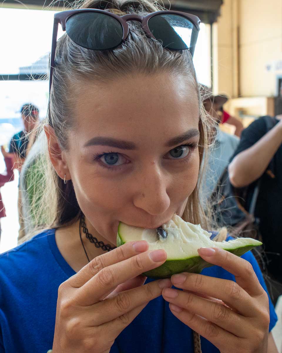 Bailey bites into a new fruit she tried on a food tour in Lima, Peru