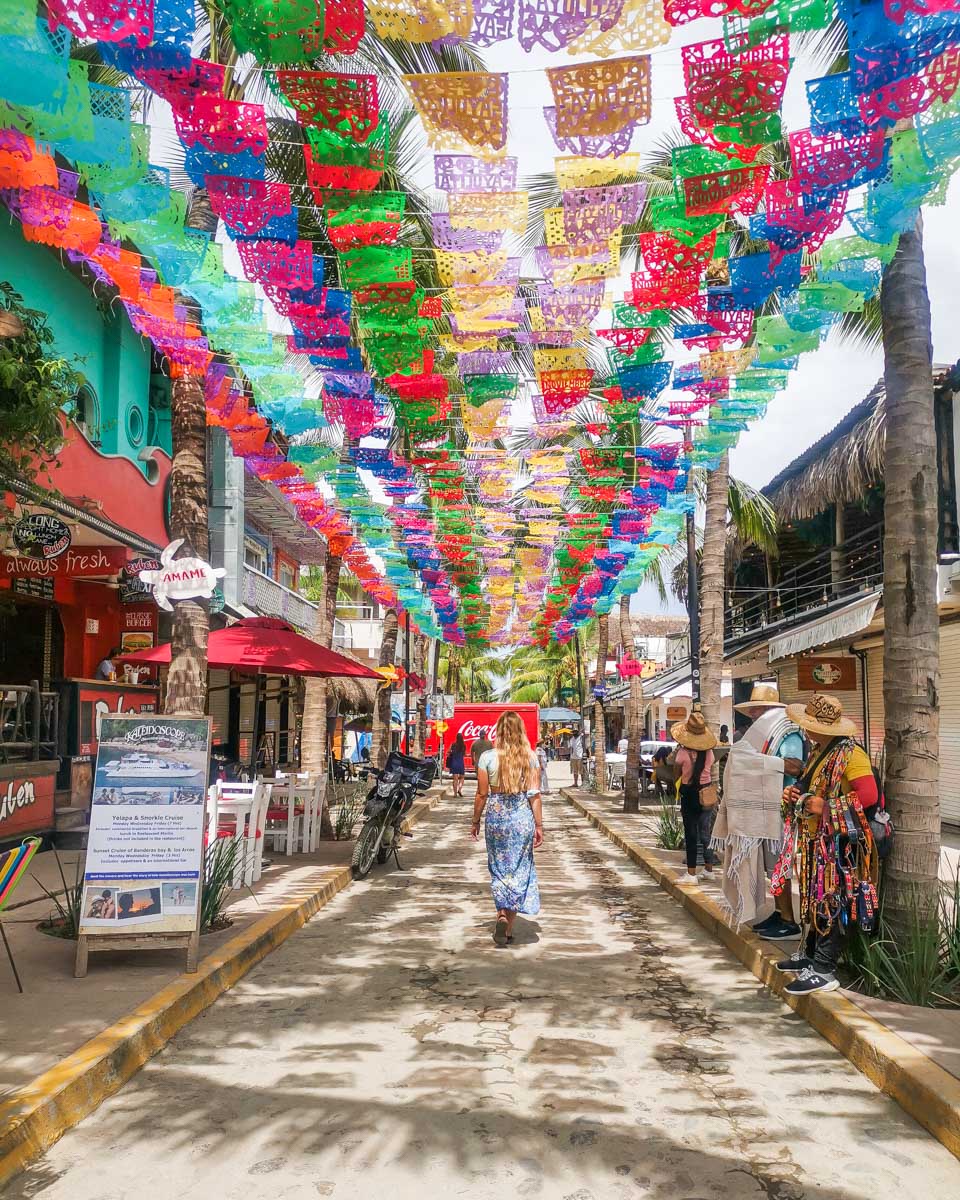 Bailey poses for a photo on a famous street in Sayulita Mexico on a photo tour from Puerto Vallarta