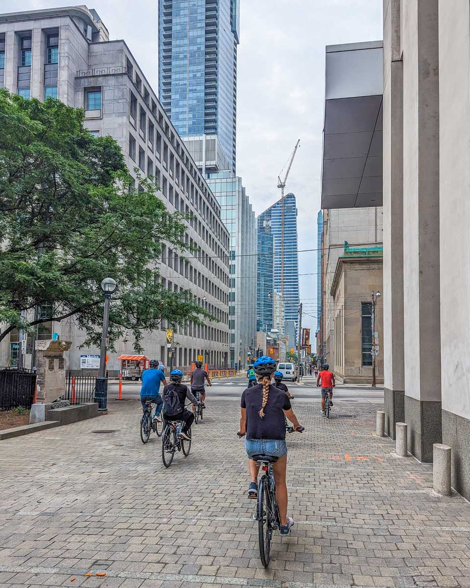 Bailey rides her bike in downtown Toronto on a tour