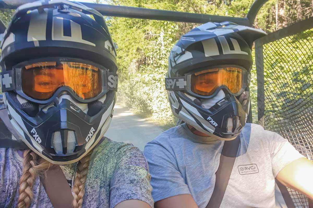 Daniel and Bailey take a selfie while driving an ATV in Tulum, Mexico