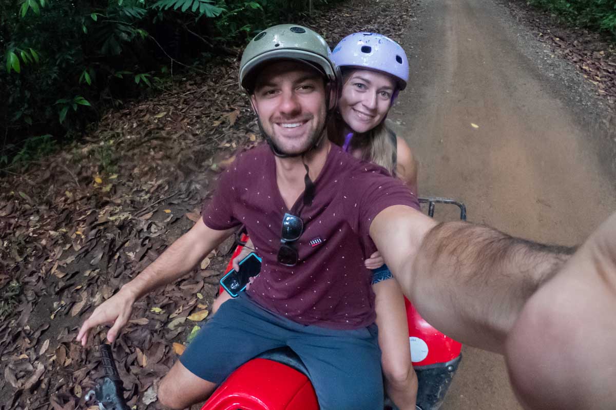 Daniel and Bailey take a selfie while riding an ATV in Tulum, Mexico