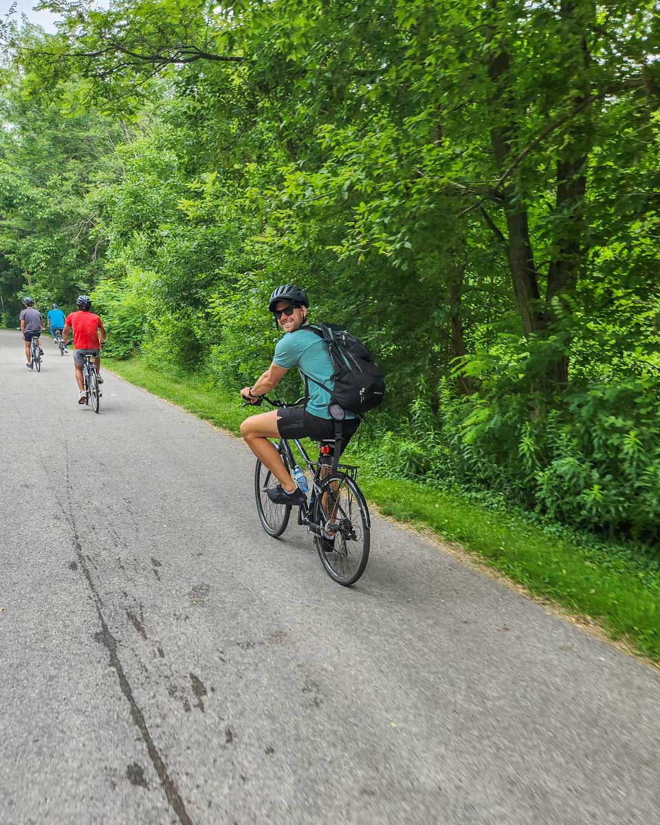 Daniel rides a bike with a tour group at the Toronto Islands