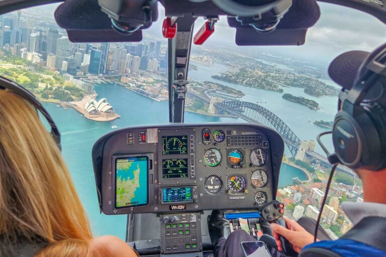 Views out the front of a helicopter as it flys over the Sydney Opera House and Sydney Harbour bridge