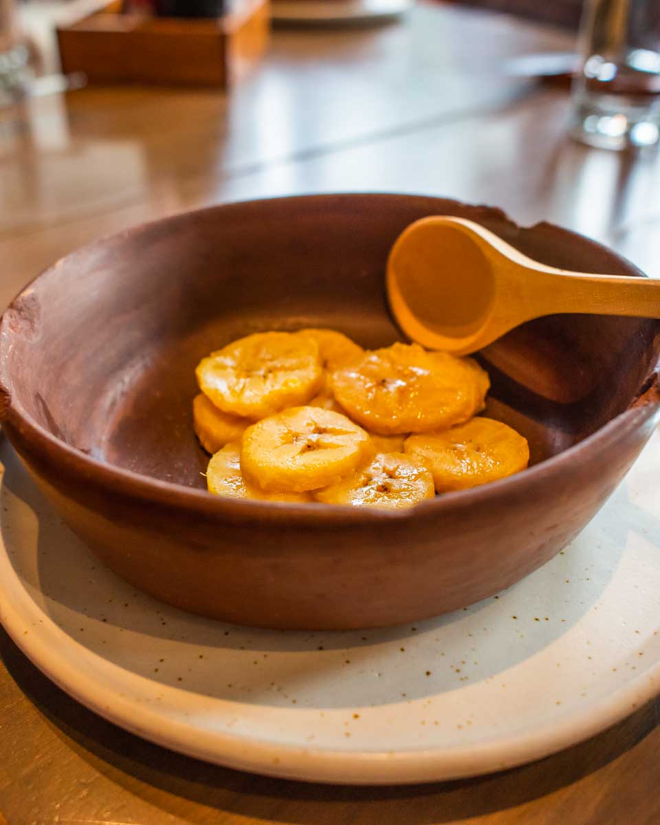 mixing plantains on a food tour in Lima, Peru