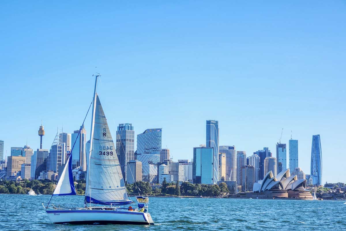 A boat sails in front of the Sydney Skyline as seen on a Sydney Harbour Cruise