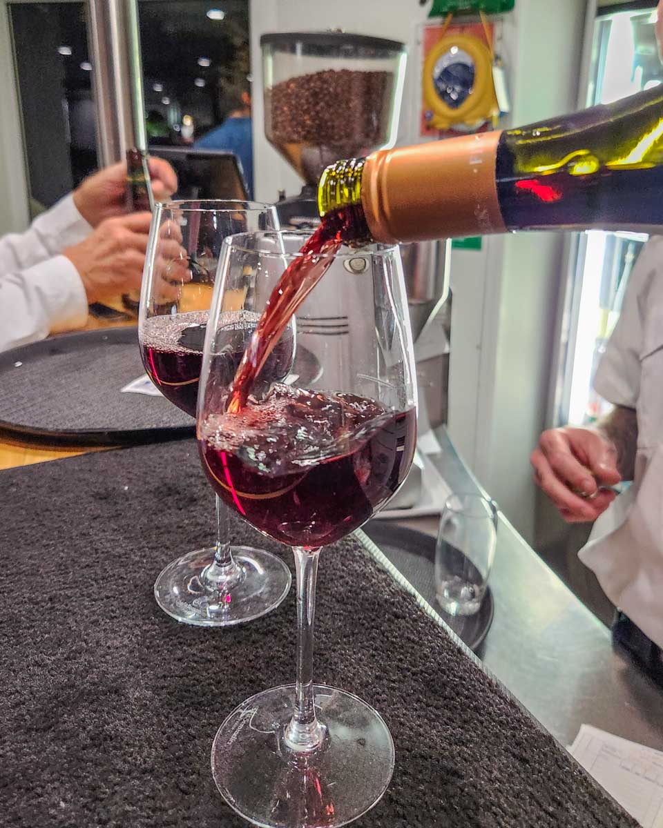A glass of wine is poured on a cruise in Sydney Harbour