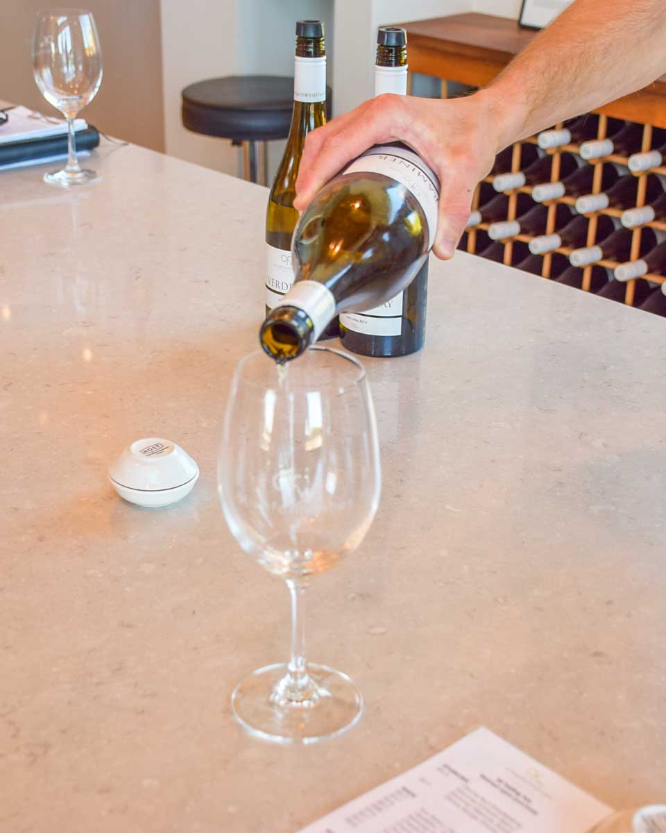 A tasting glass of wine is poured at a winery in the Swan Valley on a wine tour
