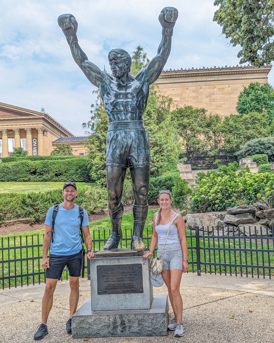 Bailey and Daniel pose for a photo with he Rocky Statue in Philadelphia
