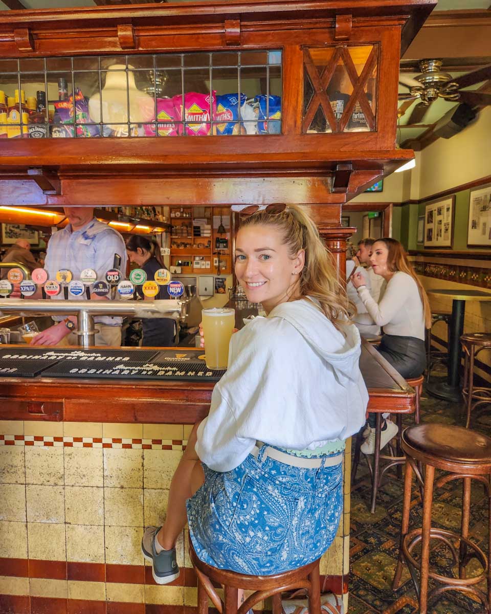 Bailey enjoys a drink at the Fortunes of War historic pub in The Rocks Sydney while on a historic pub tour