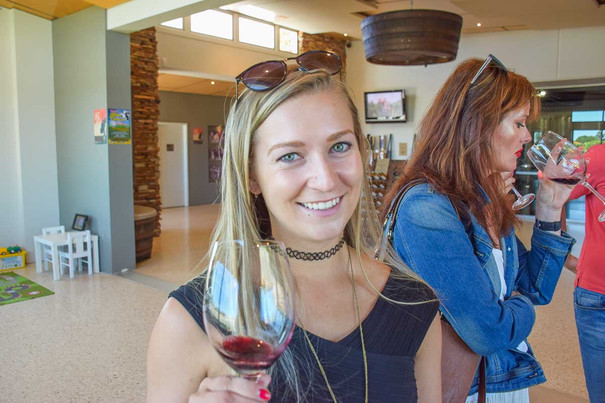 Bailey with a glass of wine int he Swan Valley on a wine tour