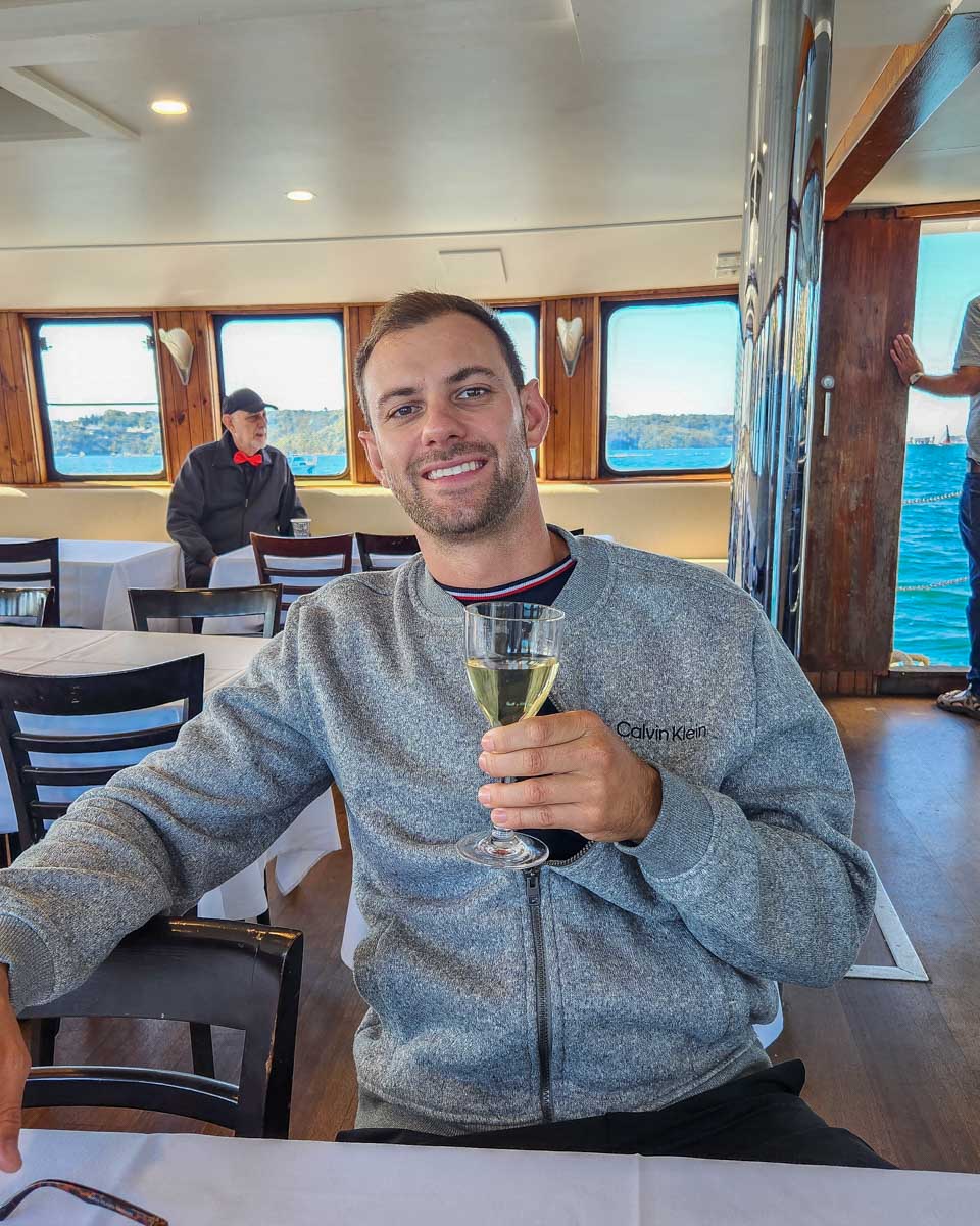 Daniel enjoys a glass of wine on a Sydney harbour Cruise