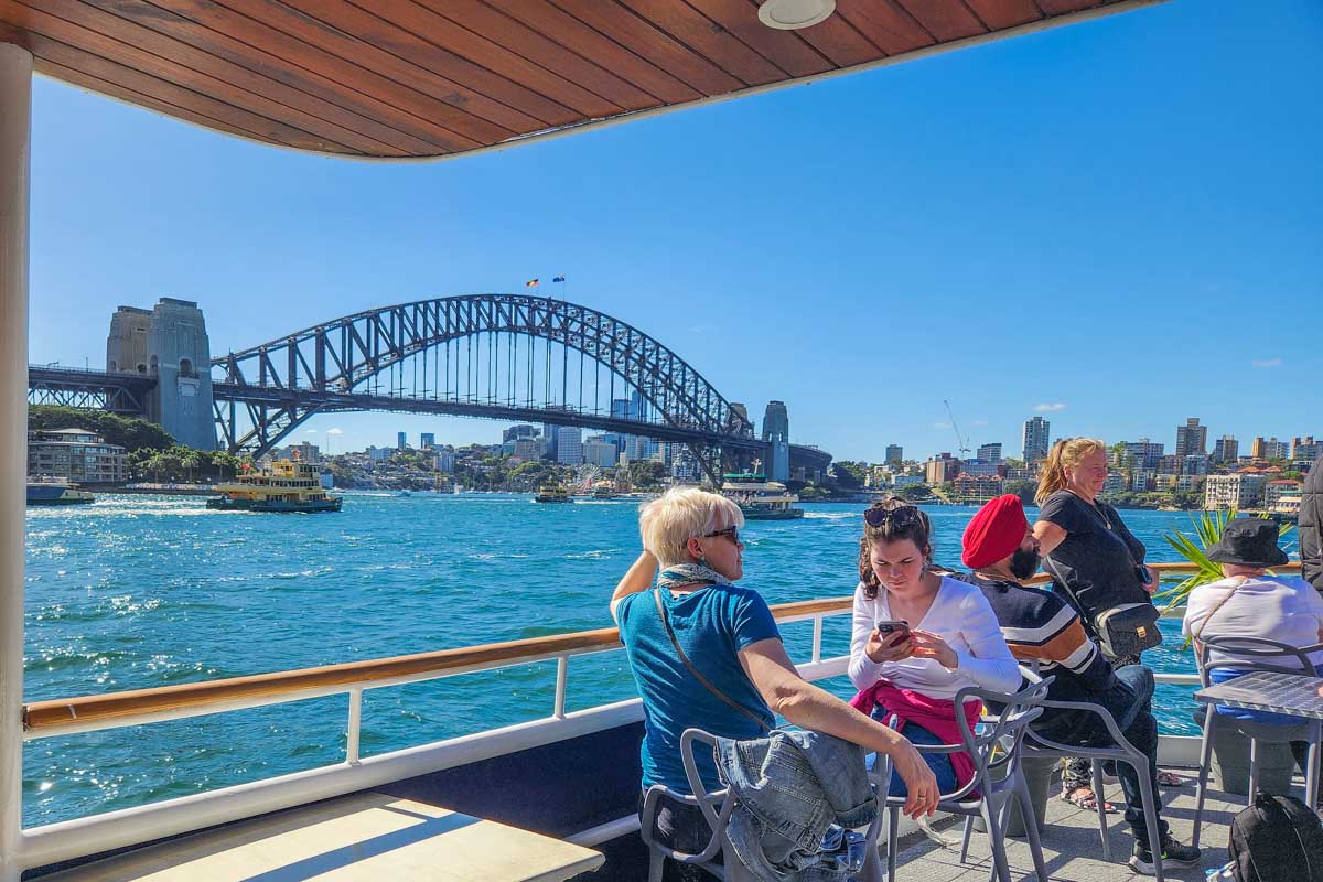 People enjoy the view of Sydney Harbour Bridge from a Sydney Harbour Cruise