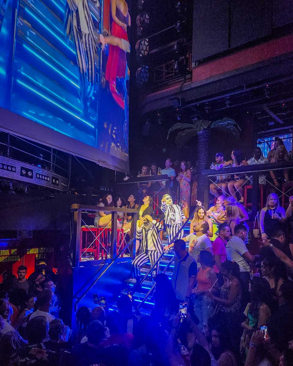 Performers walk down some stairs at Coco Bongo in costume and character