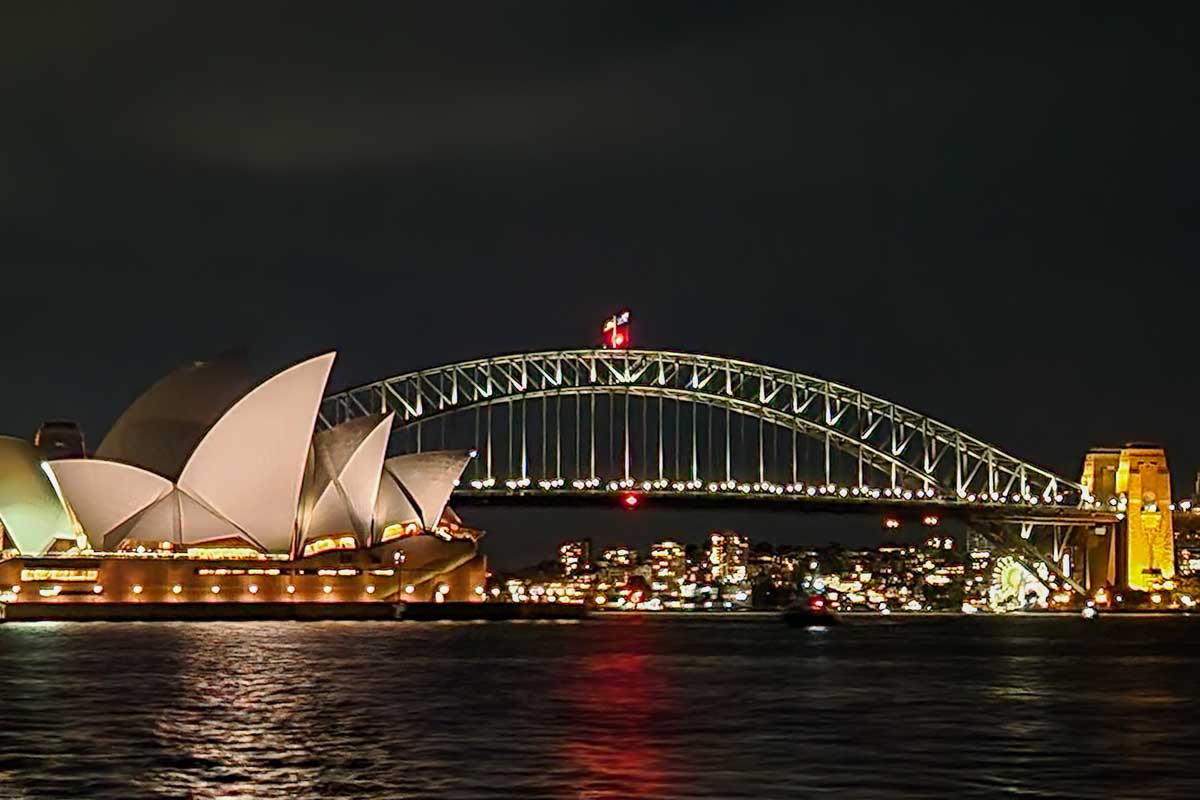 The Sydney Harbour Bridge and Sydney Opera House lit up at night from a dinner cruise in sydney, Australia