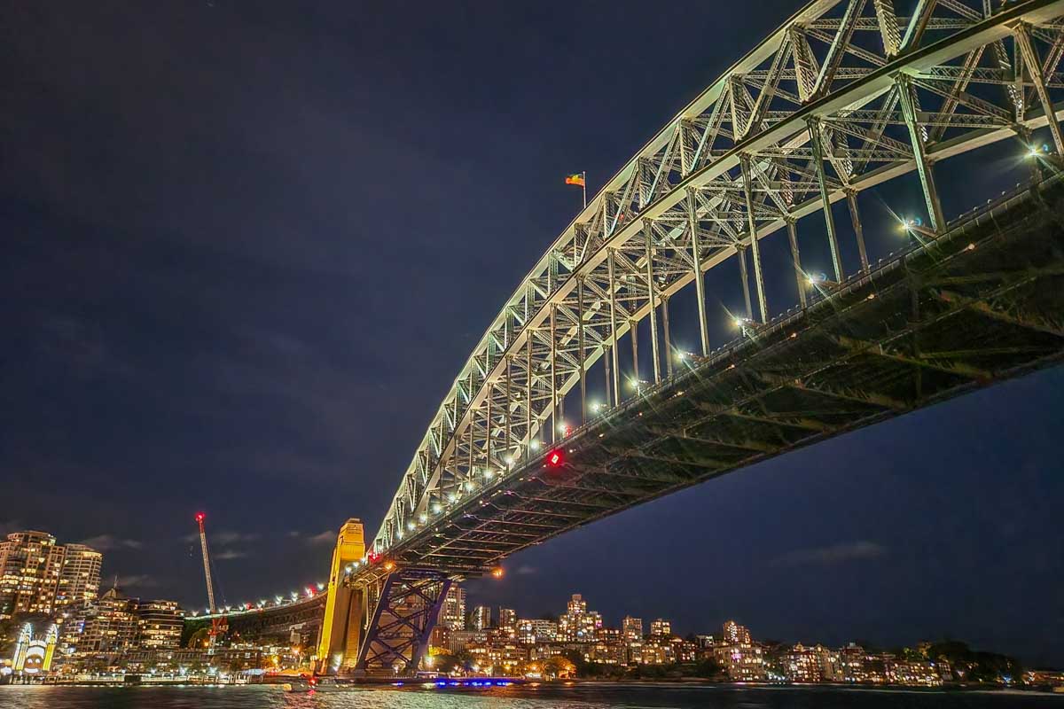 The Sydney Harbour Bridge lit up at night during the Journey Beyond the Cruise Sydney