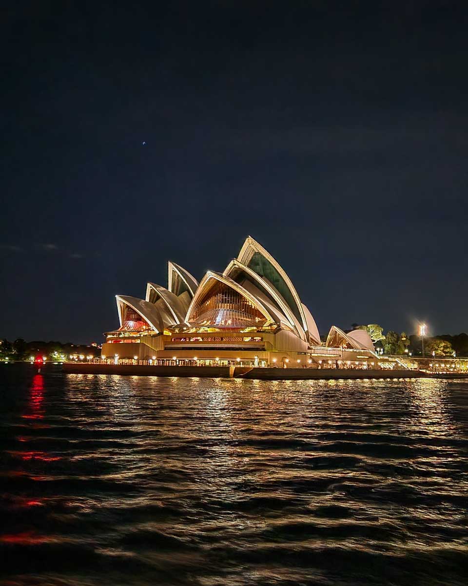 The Sydney Opera House lit up at night as seen from the Journey Beyond the Cruise Sydney