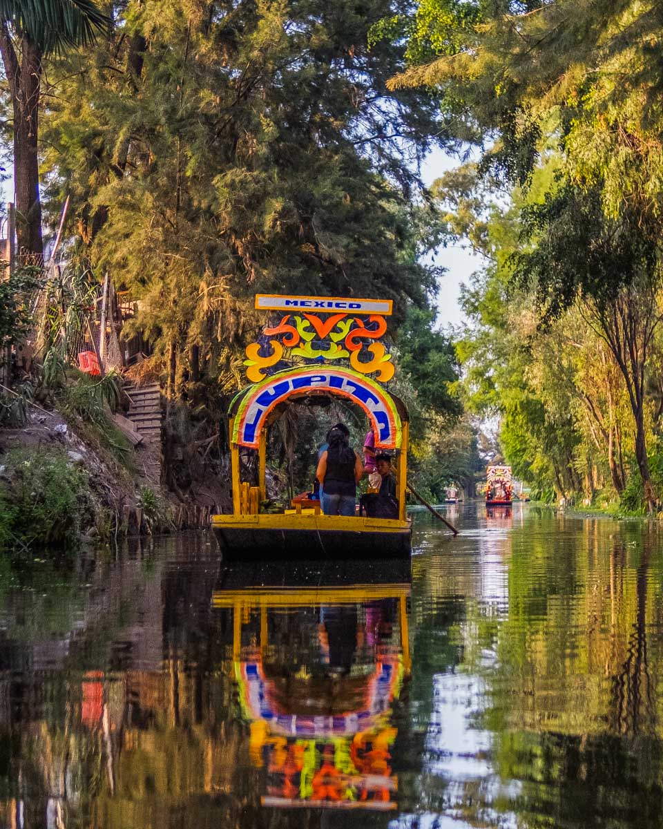 Xochimilco Canals with a colorful boat during a tour from Mexico City