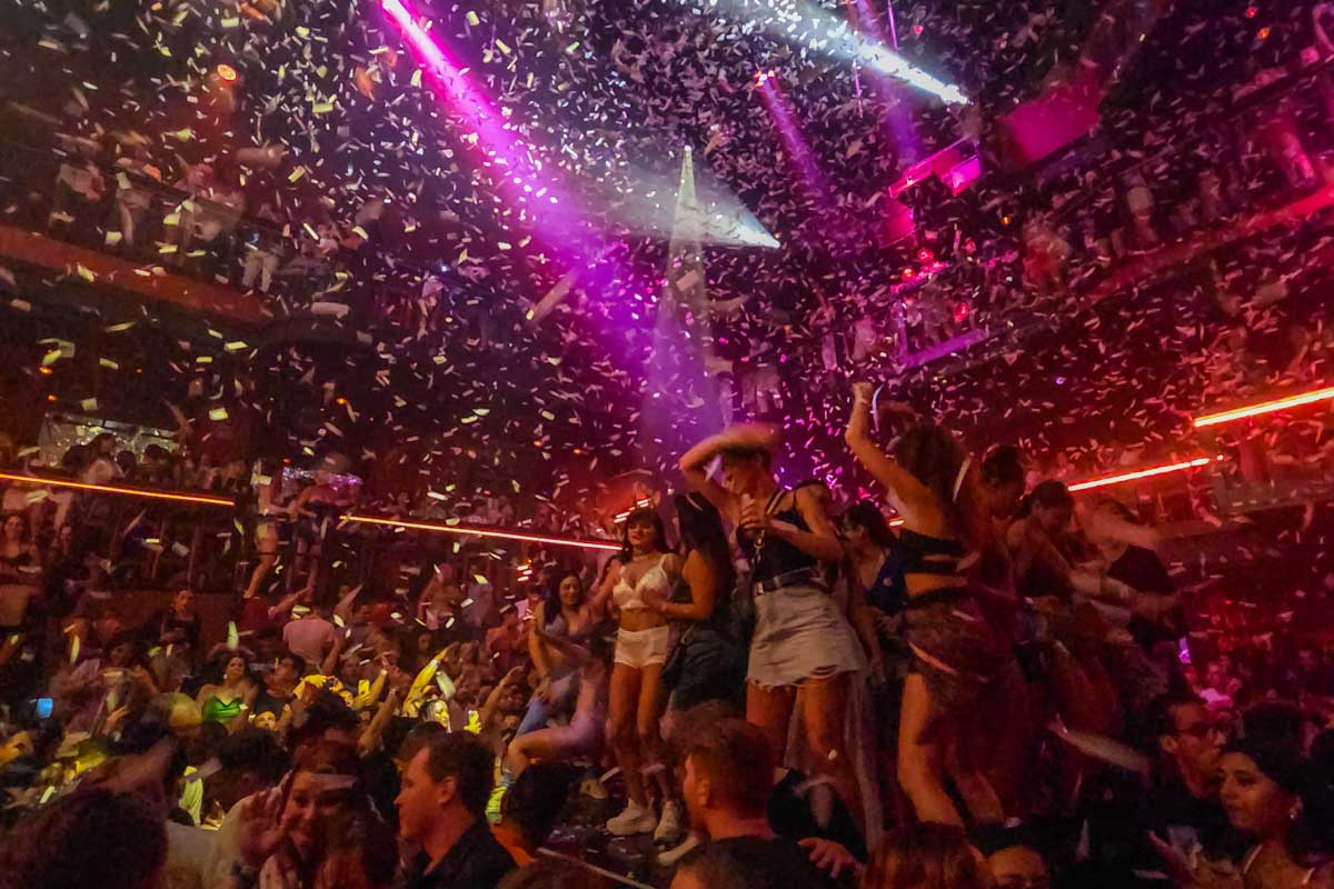 paper falls from the roof at Coco Bong while people dance