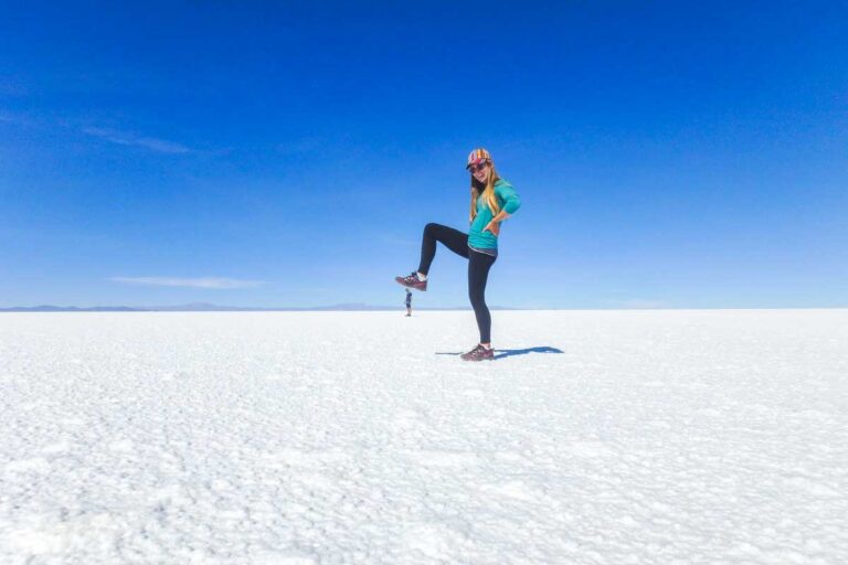 Bailey uses the Uyuni Salt Flat to take a funny photo that looks like she is stepping on Daniel