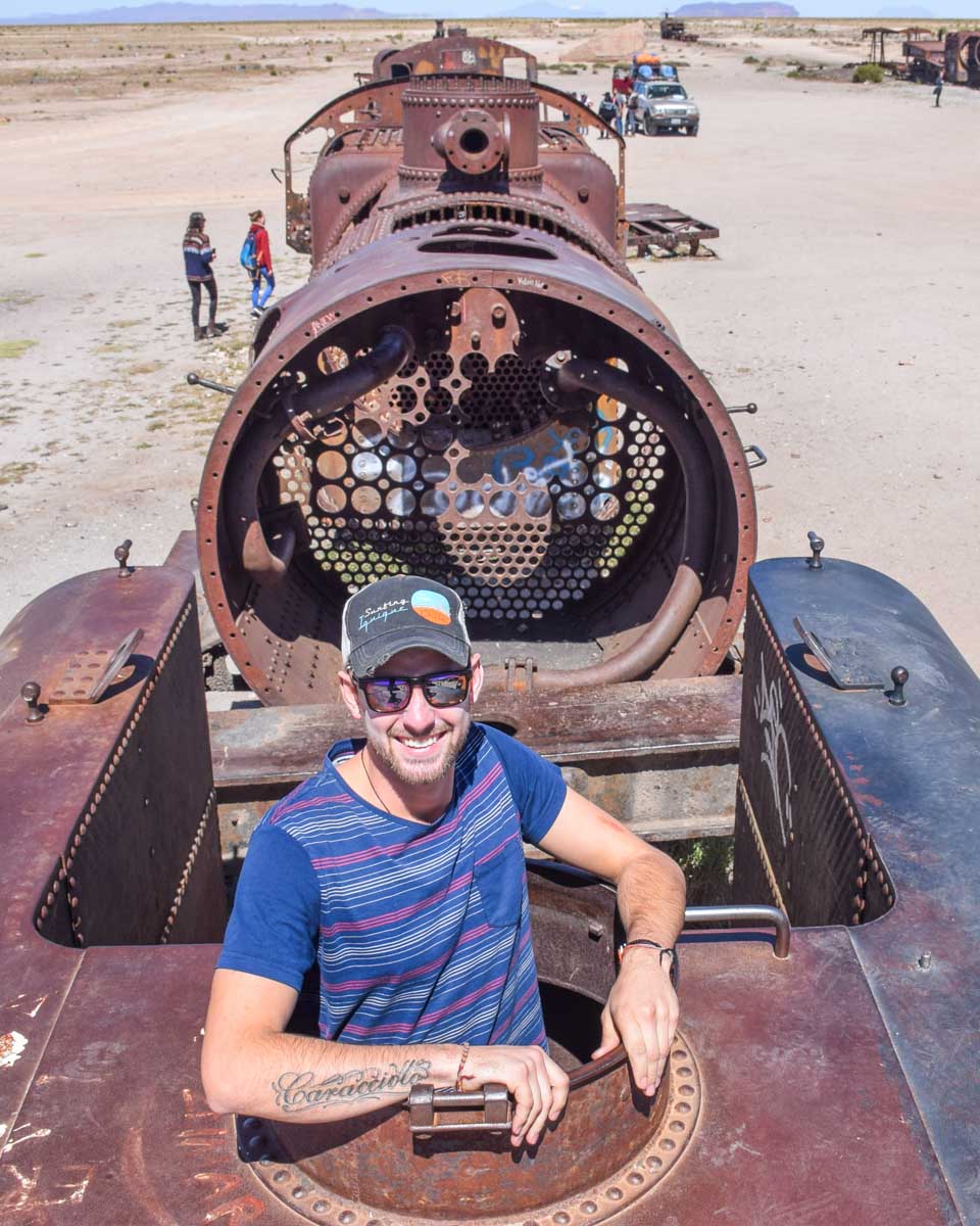 Daniel climbs inside a train at the Train Graveyard at Uyuni Salt Flat in Bolivia