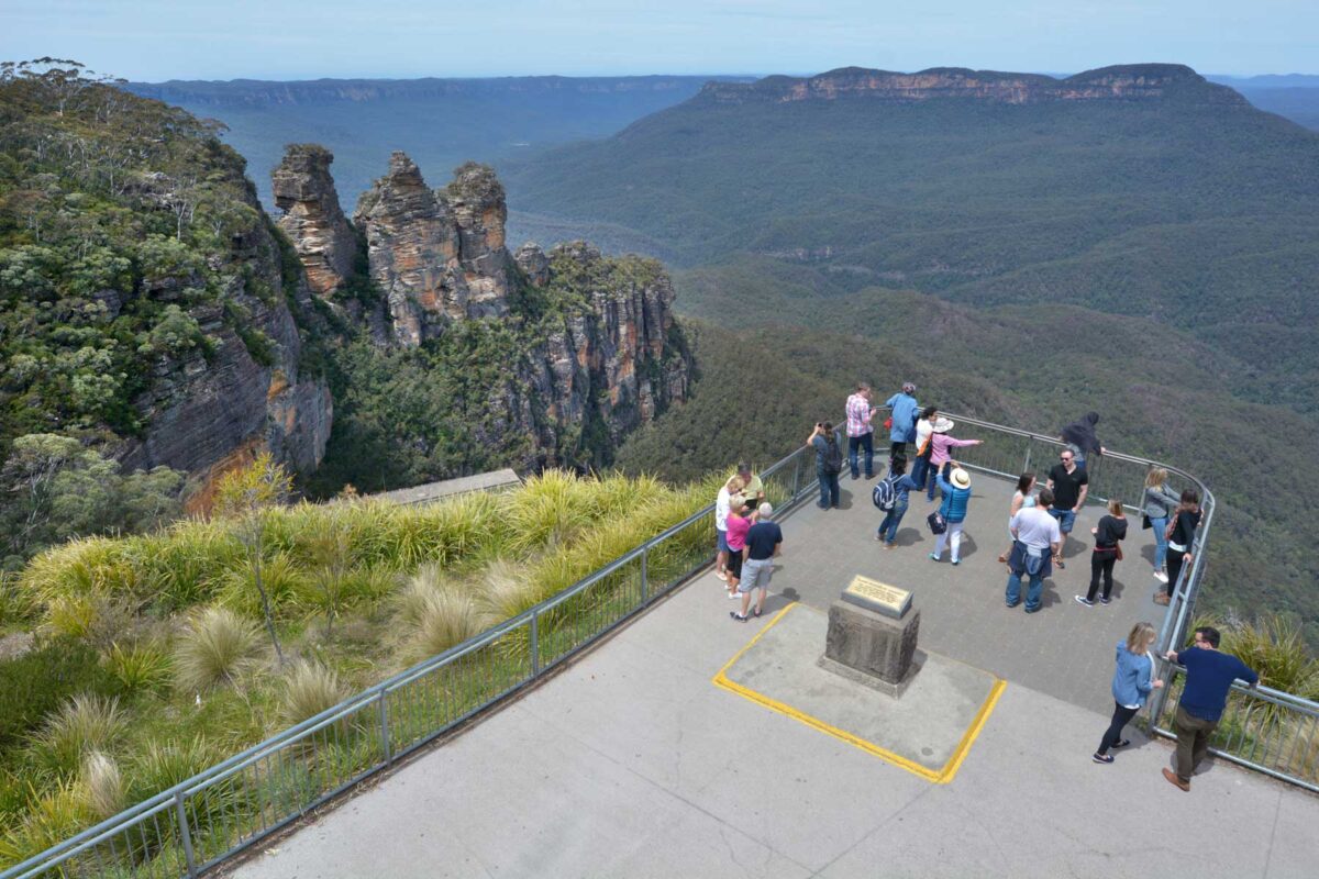 People stand on the three Sisters Lookout in Blue Mountains National Park, Sydney