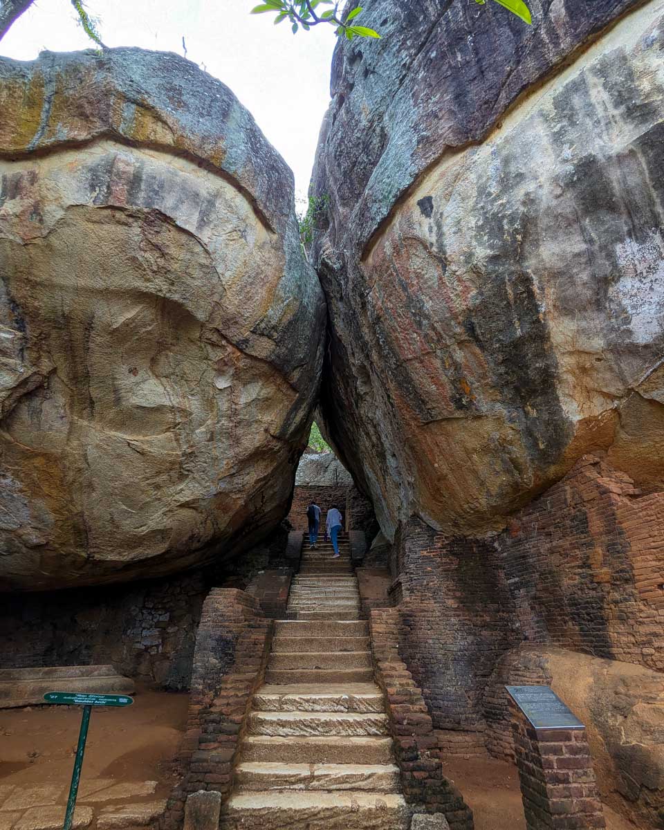 Stairs leading through two massive rocks at Sigiriya Sri Lanka