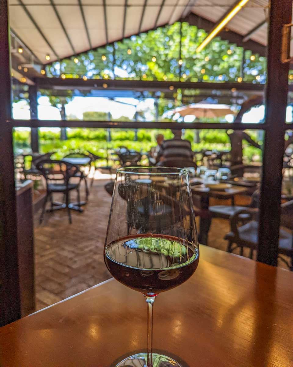 A glass of wine on a table at a winery in the Hunter Valley, Australia
