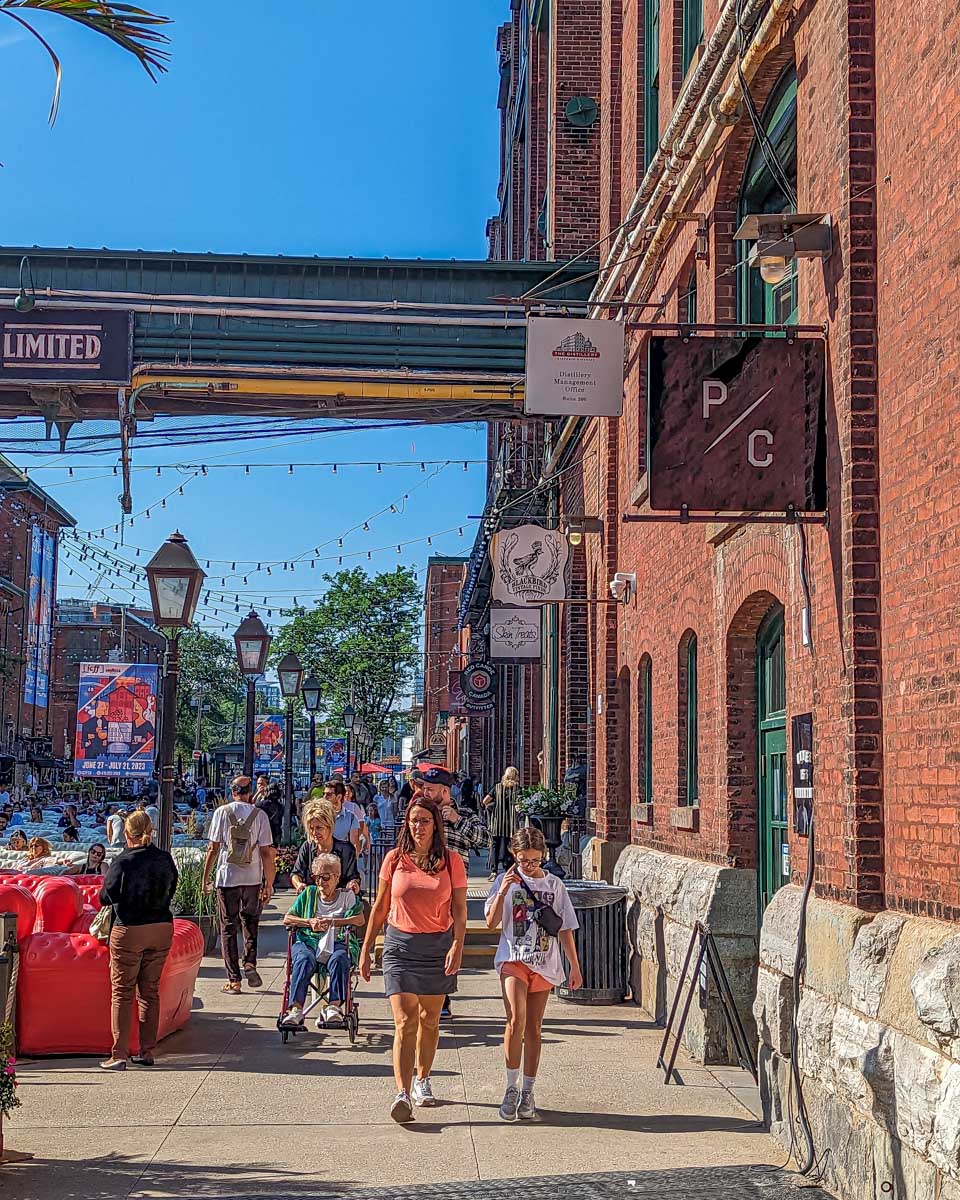 People walk through the Toronto Distillery District on a summers day in Toronto, Canada