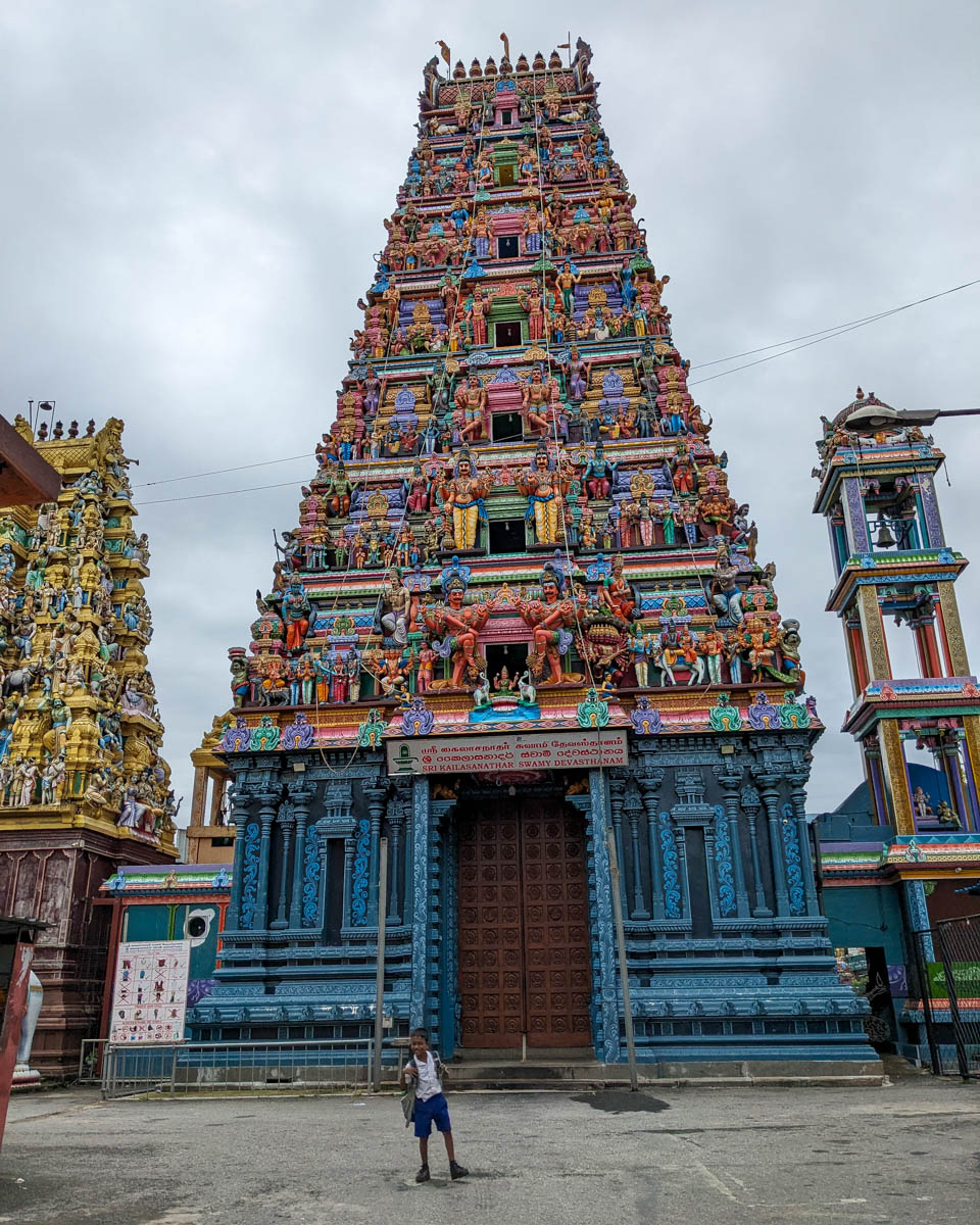 A Sri Lankan boy runs in front of the Sri Kaleshwaram Hindu Temple Colombo, Sri Lanka