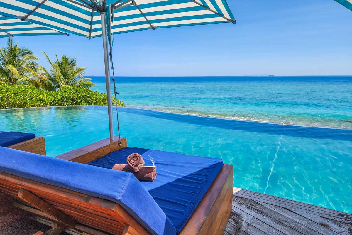 A day bed by the infinity pool at Malamala Beach Club in Fiji