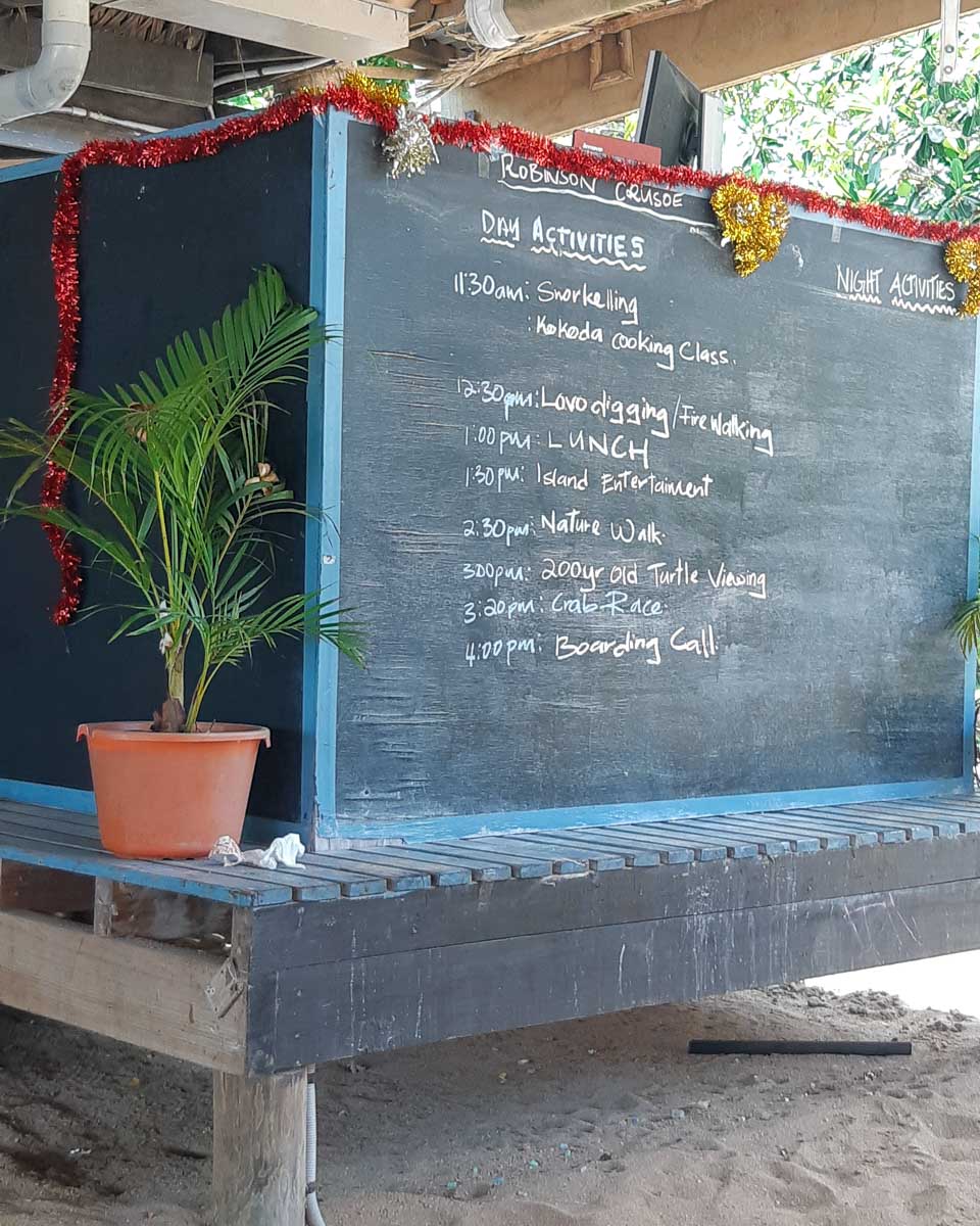A list of daily activities on a chalk board to do at robinson crusoe island fiji