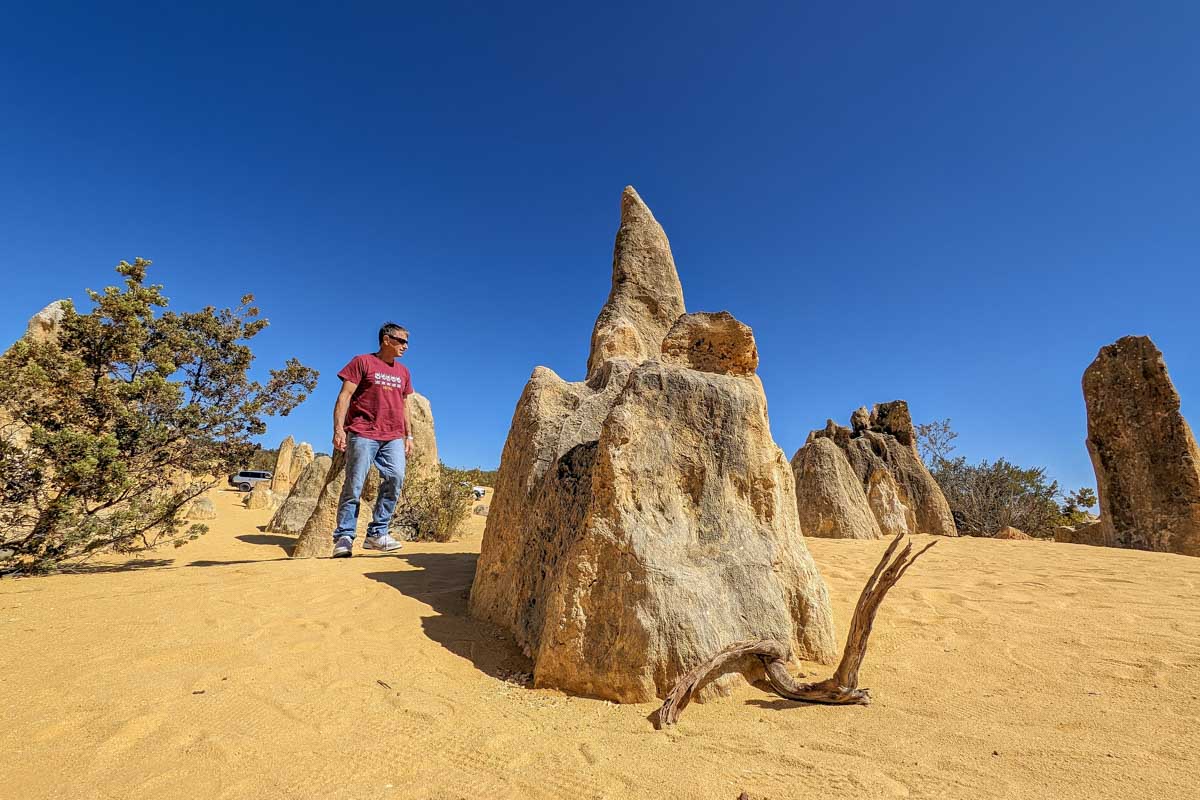A man stands by a pinnacle in australia