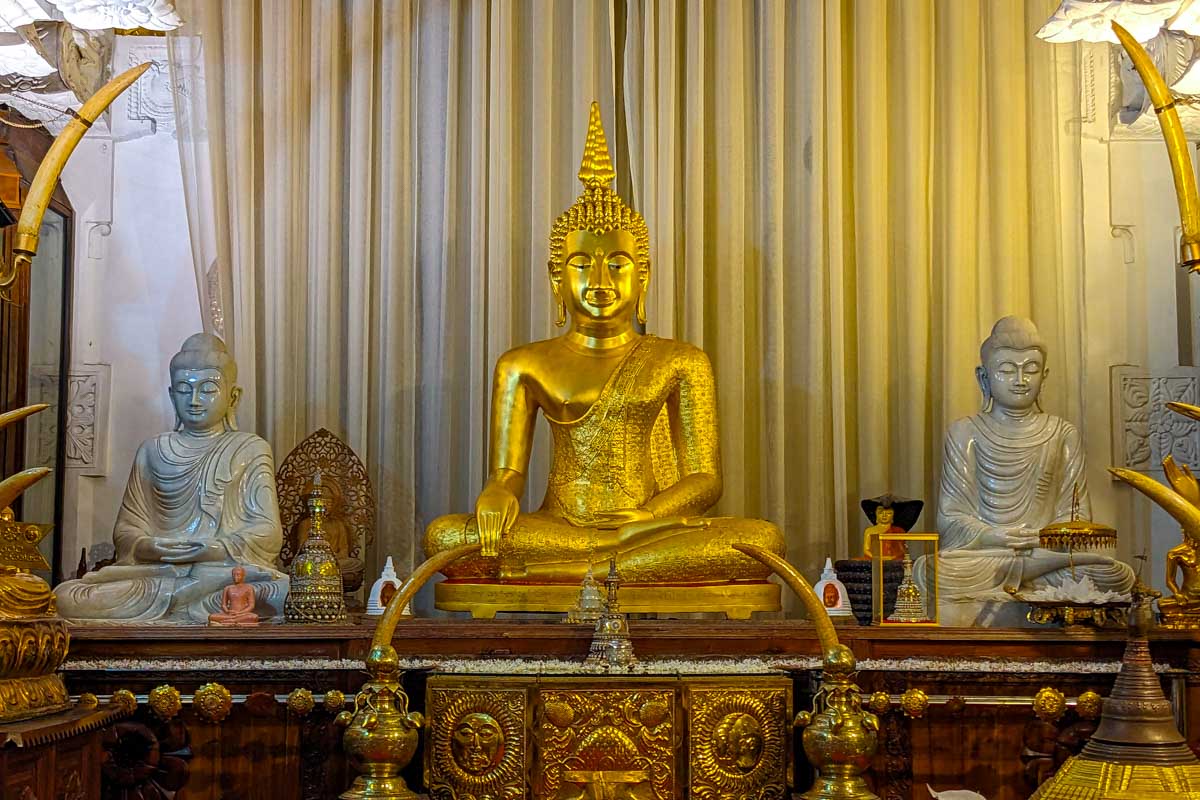 A statue of a golden Buddha at the Sacred Tooth Temple Kandy Sri Lanka