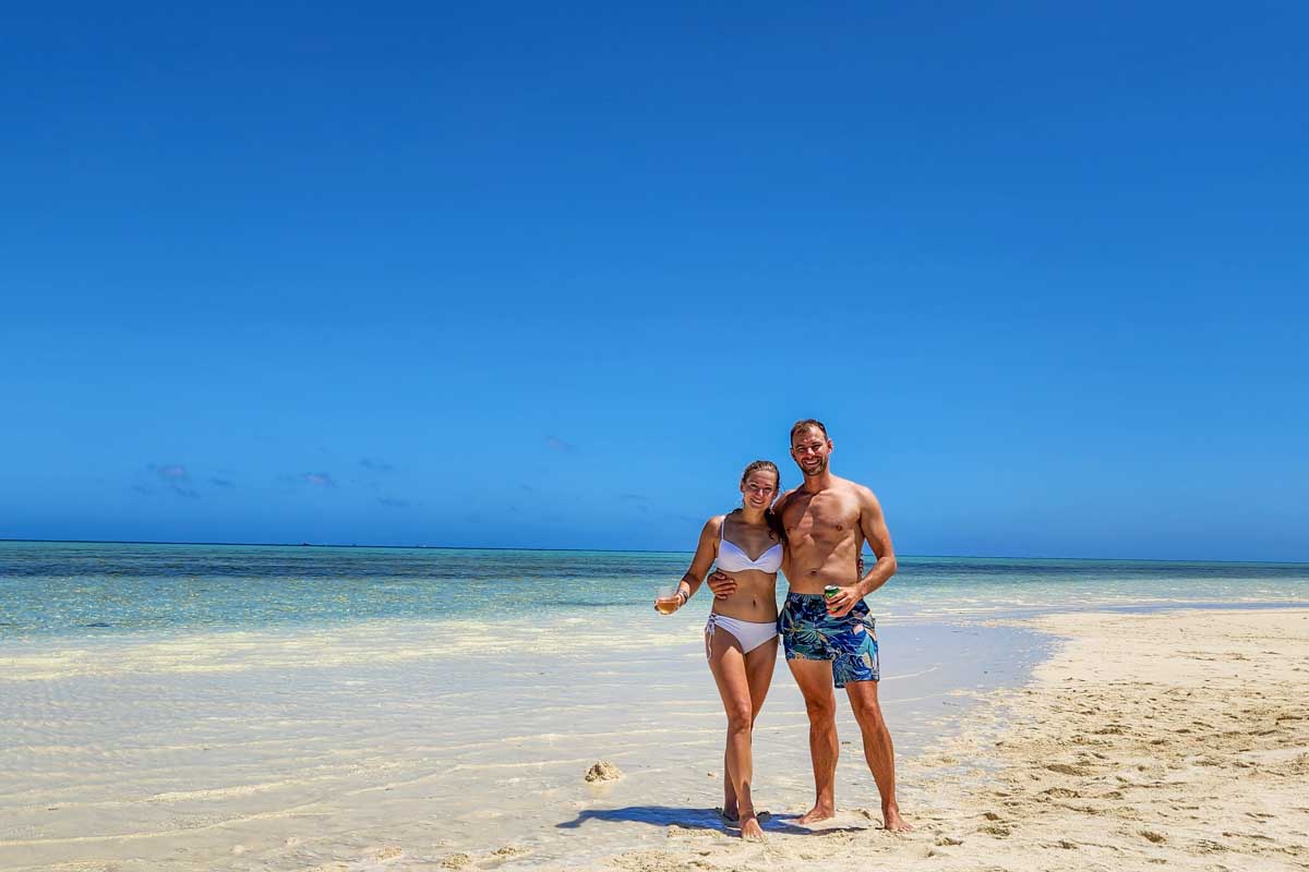 Bailey and Daniel pose for a photo on the beach at South Sea Island, Fiji