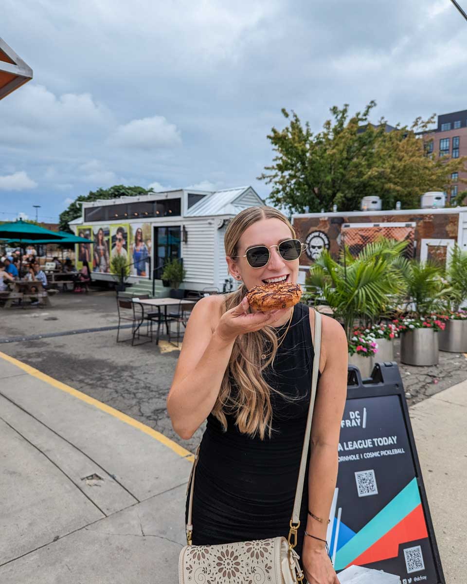 Bailey eats a doughnut at Union Market in Washington DC