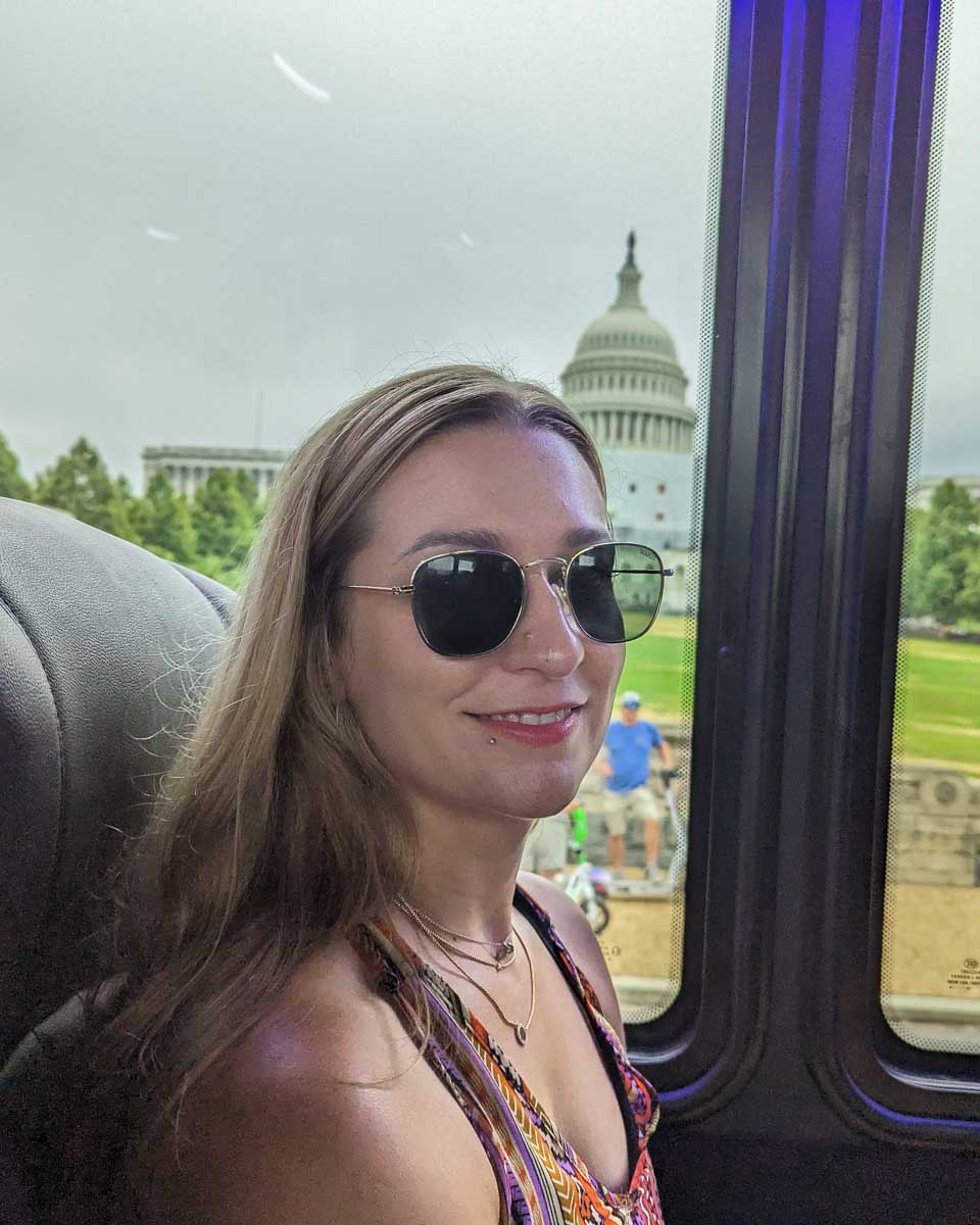 Bailey on a tour bus in Washington DC with the Capital Building in the background