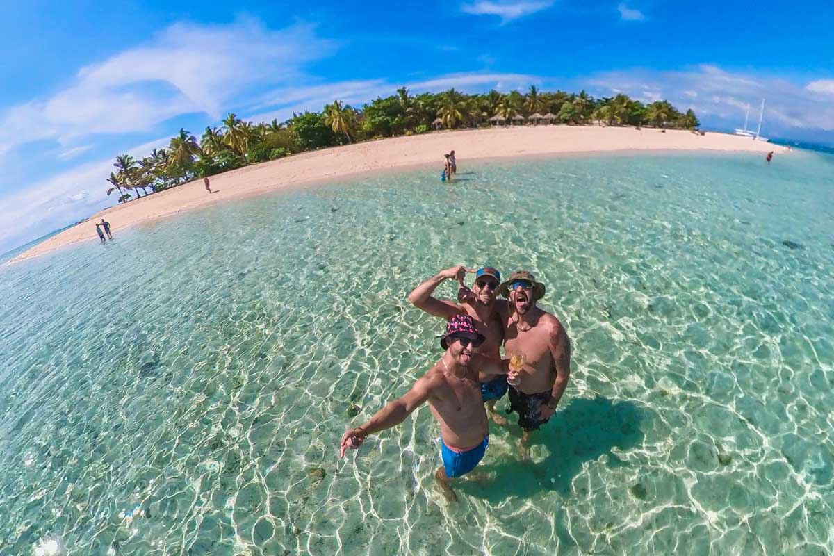 Daniel and his friends take a selfie in the shallow waters of South Sea Island