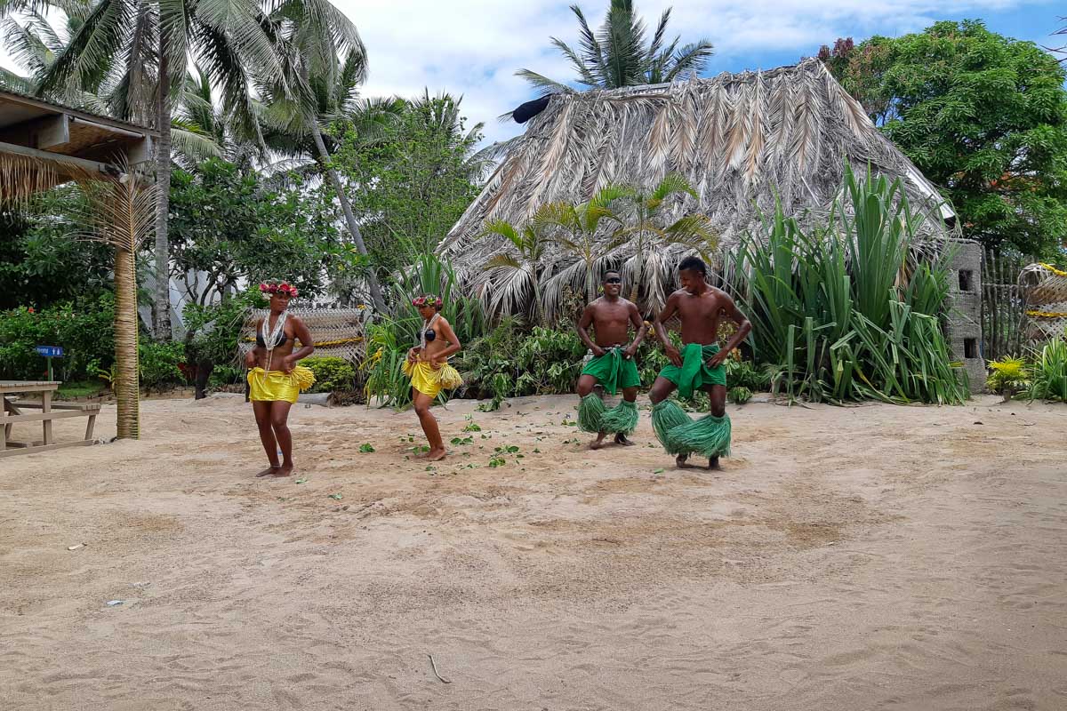 Fijians do a cultural dance in traditional outfits during the day robinson crusoe island fiji