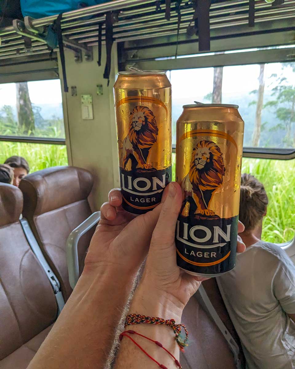 Holding some beers you can buy on the train on the way to Ella Sri Lanka