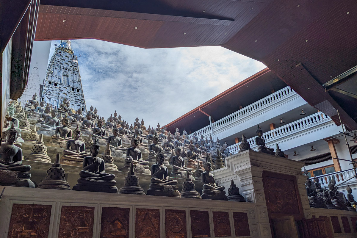 Hundreds of small stone Buddha statues in different meditation poses on display at Gangarama temple Colombo, Sri Lanka