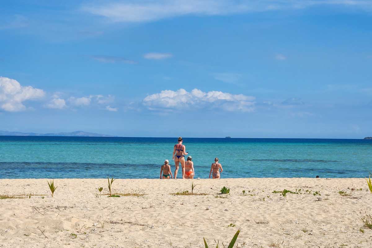 People relax on the beach during the Whale’s Tale Day Cruise in Fiji
