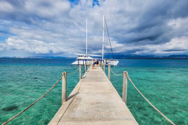 The jetty leads through the shallow waters to the boat at Tivua Island in Fiji