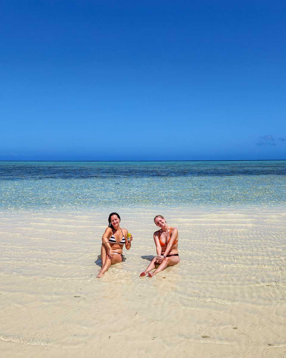 Two people relax in the shallow waters of South Sea Island, Fiji