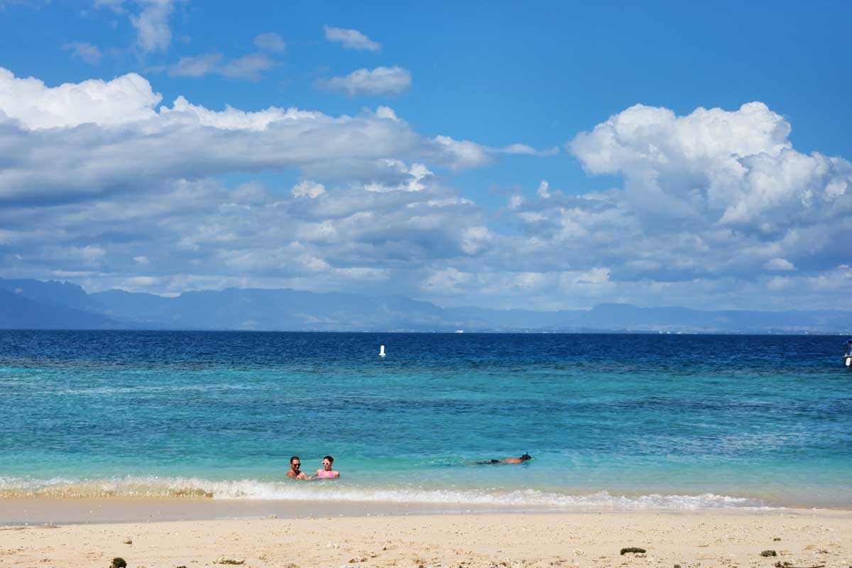 Two people swim in the ocean at Castaway Island Fiji
