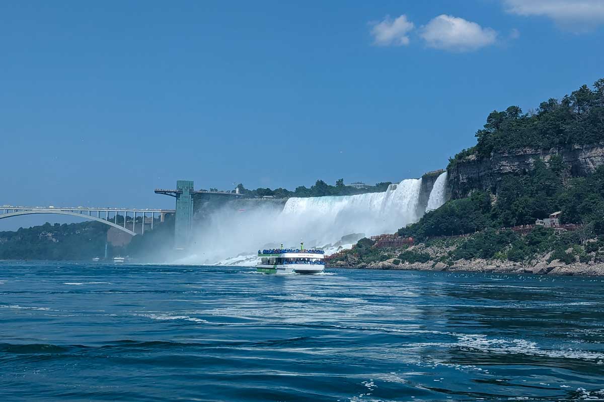 A boat of tourists going towards niagara falls canada