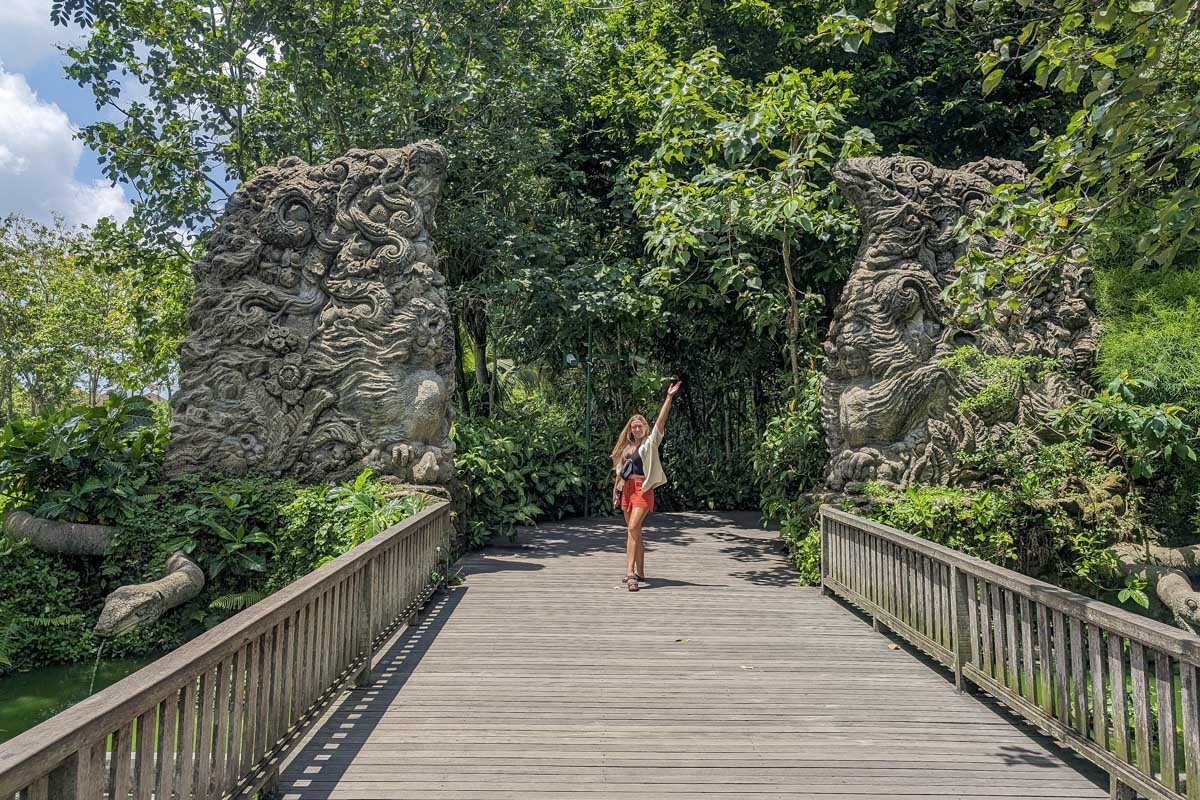 Bailey poses by some stone carvings on a walkway at Ubud Monkey Forest Bali