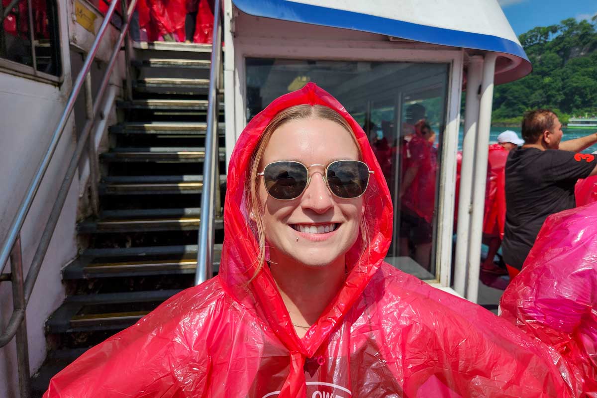 Bailey smiling in her red plastic cover to keep her from getting wet at niagara falls canada