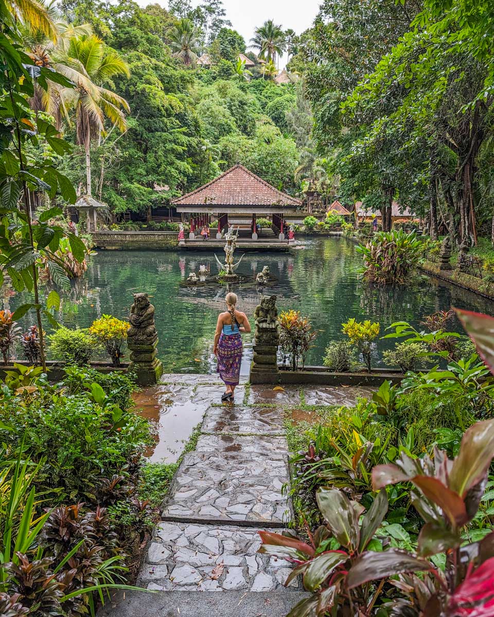 Bailey walks along the pond at Pura Gunung Kawi in Ubud, Bali